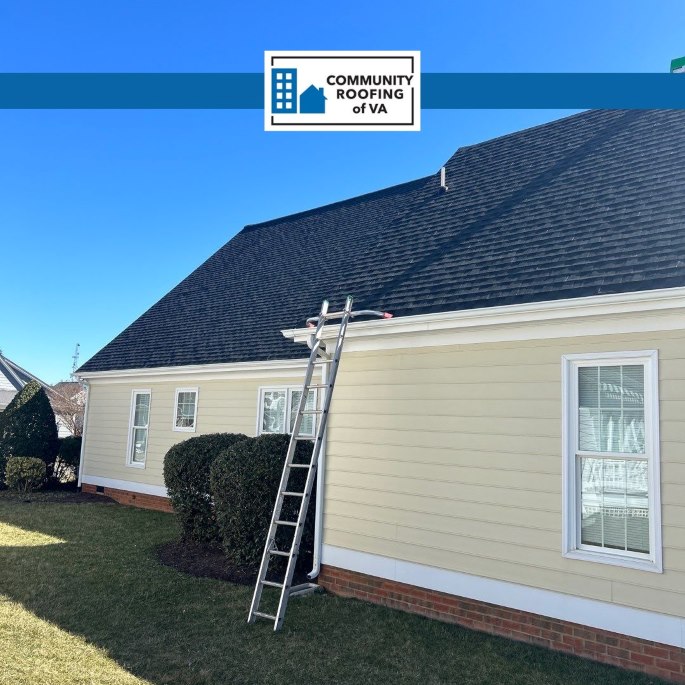Residential home with yello siding and new charcoal asphalt roof installed by Community Roofing of VA